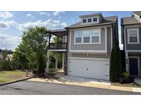 Charming two-story home featuring a balcony, two-car garage and neutral color palette at 301 Hayden Cir, Woodstock, GA 30189