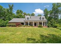 Charming single Gathering home featuring a covered front porch and well-manicured landscaping at 3990 Wesley Chapel Rd, Marietta, GA 30062