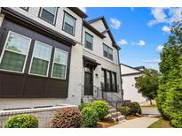 Charming two-story townhome with painted brick, black trim, and beautiful landscaping at 4776 Highside Way, Smyrna, GA 30082