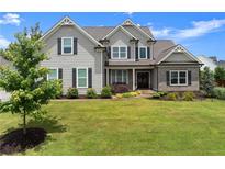 Charming two-story home with landscaped front yard, inviting curb appeal, and a classic architectural design at 7820 Longview Dr, Cumming, GA 30041
