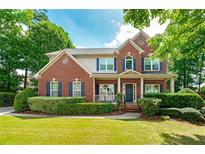 Beautiful two-story brick home with manicured lawn and charming front porch at 1120 Bagwell Dr, Kennesaw, GA 30152