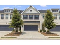 Charming townhome with a modern exterior, featuring a two-car garage and well-manicured front yard at 3546 Sorrel Ln, Duluth, GA 30096