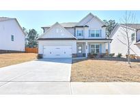 Charming two-story home with a two-car garage and a well-maintained lawn and blue accent shutters at 3557 Bryant Meadows Cir, Buford, GA 30519