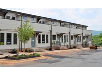 Charming new townhomes with inviting entrances and manicured landscaping line a freshly paved street at 297 White St # 1, Marietta, GA 30060