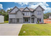 Stunning two-story home with a three-car garage and a well-maintained front yard at 37 Deer Canyon Dr, Auburn, GA 30011