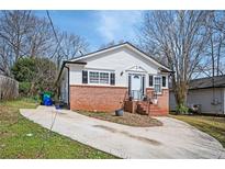 Charming single-story home with brick foundation, white siding, and well-maintained front yard at 3162 Alston Drive Dr, Decatur, GA 30032