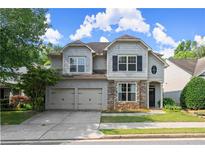 Charming two-story home with stone accents, neutral siding, and well-maintained landscaping and a two car garage at 510 Winder Trl, Canton, GA 30114