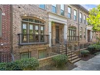 Charming brick townhome features a wrought iron balcony and manicured landscaping at 2380 Crescent Park Ct # 4, Atlanta, GA 30339