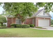 Charming brick home featuring a well-manicured lawn and attached two car garage in a desirable community at 1239 Brentwood Ct, Douglasville, GA 30135