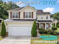 Charming two-story home featuring manicured landscaping, a two-car garage, and inviting front porch at 3609 Indigo Creek Nw Trl, Kennesaw, GA 30144