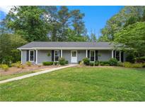 Charming single-story home with well-manicured lawn and gray siding at 3131 Garden Lane Dr, Marietta, GA 30062