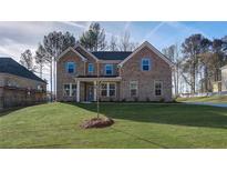 Charming two-story brick home with a manicured lawn and inviting front entrance at 308 Delta Dr, Mcdonough, GA 30253