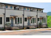 Modern townhome with brick accents, sleek black window frames, and stylish wooden accents over the entryways at 289 White St # 3, Marietta, GA 30060