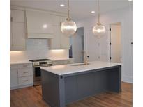 Elegant kitchen featuring a spacious island, stainless steel appliances, and modern pendant lighting at 289 White St # 3, Marietta, GA 30060