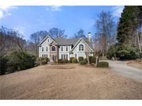 Charming two-story home featuring a well-maintained lawn, mature trees and ample parking at 3819 Trotters Run, Douglasville, GA 30135
