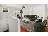Living room with hardwood floors, green furniture, modern fixtures, and lots of natural light at 1168 Liberty Nw Pkwy, Atlanta, GA 30318