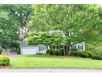 Charming single-Gathering home with lush landscaping and a well-maintained front yard at 241 Tweed Ct, Sugar Hill, GA 30518