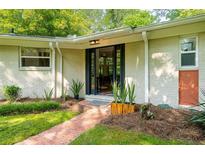 Inviting front entrance with brick walkway and freshly landscaped plants adds curb appeal to this charming home at 2349 Echo Cliff Ne Ct, Atlanta, GA 30345