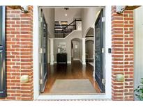 Grand foyer showcasing dark wood floors, staircase, and wrought iron railing at 302 Shawnee Indian Ln, Suwanee, GA 30024
