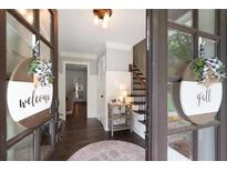 Inviting entryway featuring hardwood floors, stylish decor, and a staircase at 3600 Morishop Nw Cv, Marietta, GA 30064