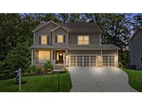 Charming two-story home with a welcoming front porch, well-manicured lawn, and three-car garage at 6045 Stargazer Way, Cumming, GA 30028