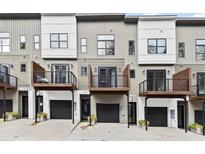 Modern townhome exterior featuring individual balconies and attached garages for convenient city living at 2329 Mason Dr # D24, Atlanta, GA 30316