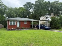 Charming brick home with a well-manicured lawn and convenient carport at 2431 Crestview Ave, Decatur, GA 30032
