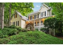 Charming two-story home with a welcoming front porch and well-manicured landscaping at 2722 Brookhaven Ln, Buford, GA 30518