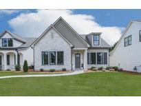 Charming single-Gathering home featuring a stone facade, manicured lawn, and black trimmed windows at 158 South Village Ave, Holly Springs, GA 30115