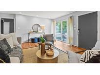 Comfortable living room featuring a textured rug, modern furniture, and natural light at 3048 Briarcliff Ne Rd # 8, Atlanta, GA 30329