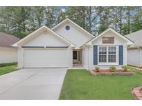 Charming one-story home with a well-manicured lawn, two-car garage and inviting curb appeal at 713 S Fairfield Dr, Peachtree City, GA 30269