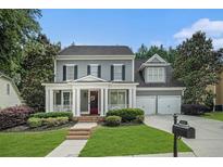 Charming two-story home with manicured lawn, inviting front porch, and attached two car garage at 892 Gramercy Hills Ln, Mableton, GA 30126
