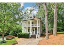 Inviting two-story home with a charming double porch and beautifully landscaped front yard at 1160 Foster Nw Pl, Atlanta, GA 30318