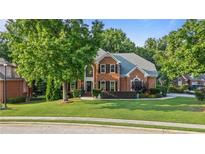 Charming two-story brick home featuring a lush lawn and well-maintained landscaping, enhancing its curb appeal at 314 Savannah Pl, Loganville, GA 30052