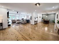 Open-concept living space with hardwood floors, neutral decor, and abundant natural light at 128 Golden Hills Dr, Woodstock, GA 30189