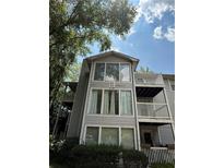 Multi-level condo building with gray siding, large windows, and balconies on a sunny day at 2107 Augusta Se Dr, Marietta, GA 30067