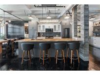 Modern kitchen featuring an island with seating, granite countertops, and stainless steel appliances at 878 Peachtree St # 601, Atlanta, GA 30309