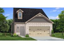 Charming home featuring a brick exterior, two-car garage, and a neatly landscaped front yard at 265 Abbotts Crossing Cir, Conyers, GA 30094