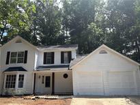 Charming two-story home with a two-car garage and mature trees, all in a desirable neighborhood at 310 Wolf Downs Way, Atlanta, GA 30349