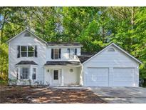Charming two-story home with a two car garage and bay window, nestled in a lush green environment at 310 Wolf Downs Way, Atlanta, GA 30349