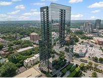 Stunning exterior of a modern high-rise condominium tower with reflective glass and beautiful city views at 3630 Peachtree Ne Rd # 2408, Atlanta, GA 30326