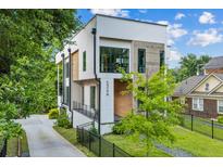 Modern exterior elevation with a two-car driveway and landscaped front yard at 536 Highland Ne Ave # A, Atlanta, GA 30312