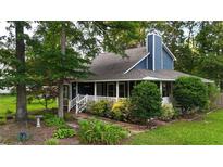 Charming blue two-story home with a landscaped front yard and covered front porch at 233 Oakridge Se Dr, Cartersville, GA 30121