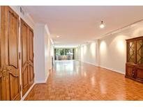 Spacious living room boasts hardwood floors, natural lighting, and detailed trim at 2734 Peachtree Nw Rd # C-404, Atlanta, GA 30305