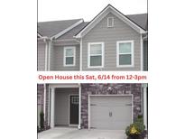 Charming townhome exterior with stone accents and a convenient attached garage at 1942 Dillon Dr, Lithonia, GA 30058