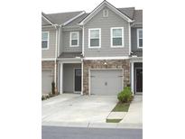 Inviting townhome with stone accents, neutral siding, and a convenient two-car garage at 1942 Dillon Dr, Lithonia, GA 30058