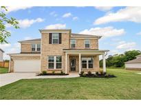 Charming two-story brick home with a well-manicured lawn and covered front porch at 120 Aj Welch Jr Way, Mcdonough, GA 30252