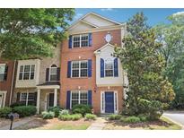 Attractive brick townhome with a well-maintained lawn, beautiful landscaping, and a charming entryway at 626 Pecan Knoll Dr # 13, Marietta, GA 30008