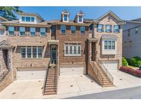 Beautiful brick townhouse with a two-car garage, landscaped front, and inviting staircase at 1382 Doublegate Ne Dr, Atlanta, GA 30319