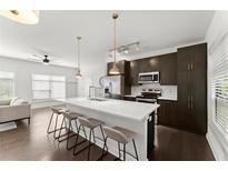 Modern kitchen features an island with seating, stainless steel appliances, and ample storage space at 19 Moda Ln, Atlanta, GA 30316